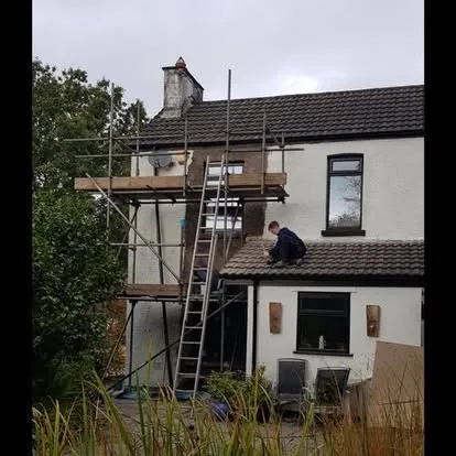 Goode Building Services carrying out roofing work from scaffolding on a Caerphilly property
